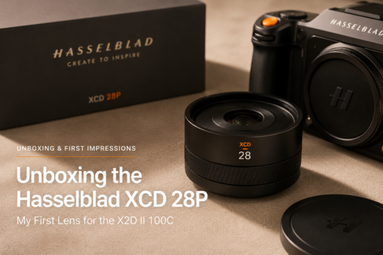 Hasselblad XCD 28P lens beside the X2D II 100C camera body and packaging during an unboxing and first impressions setup.